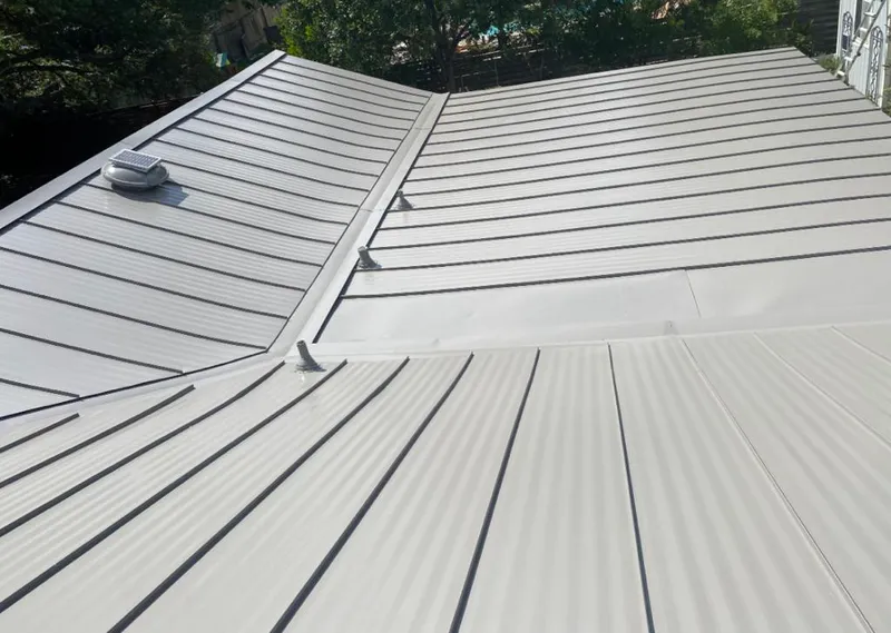 Solar attic fan installed on a metal roof for Roof Ventilation in Longswamp
